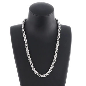 Detailed close-up of a silver stainless steel square curb chain necklace on a black mannequin