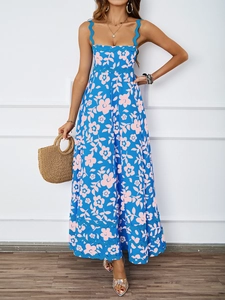 Detail of navy blue summer dress featuring pink floral prints and wavy lace trim edges