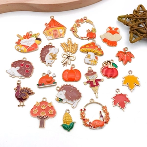 Detail view of colorful enamel autumn charms including pumpkins and maple leaves