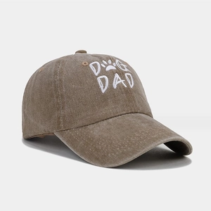 Close-up of vintage washed brown cotton baseball cap with white DOG DAD embroidery