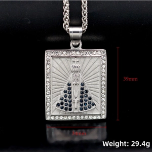 Detailed macro view of 316L stainless steel Virgin Mary pendant with blue cubic zirconia