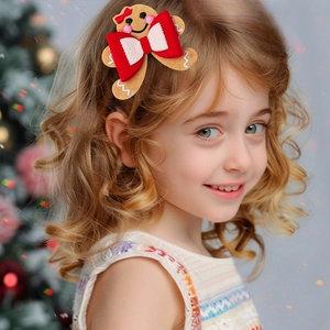 Detail of child wearing a gingerbread man Christmas hair clip with a red festive bow