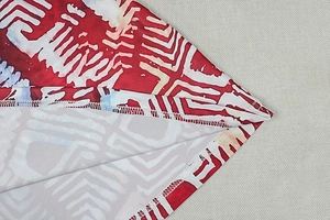 Close-up of geometric print fabric texture and white stitched seam on A-line dress