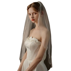 Elegant ivory white wedding veil with delicate hand-sewn beads and metal hair comb detail