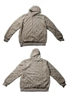 Detail of light brown fleece hoodie with diamond pattern texture and ribbed hem