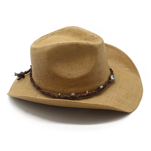 Detail of straw cowboy hat featuring brown leather band and evil eye bead charm