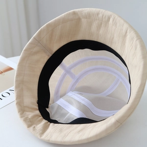 Detail view of the breathable inner lining and sweatband of this beige cotton bucket hat