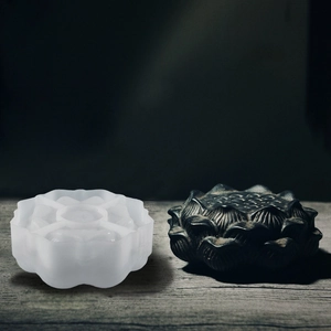Macro detail of lotus shaped silicone mold alongside finished resin craft lotus base