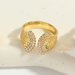 Detail of adjustable gold ring featuring sparkling zircon leaf designs and textured metal