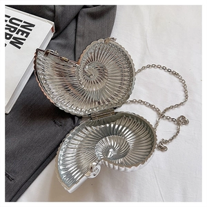 Macro view of silver snail-shaped evening bag showing internal structure and hinge details