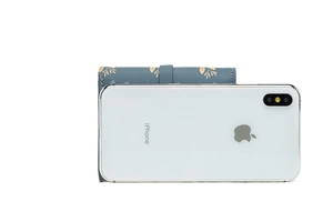 Blue trifold wallet with gold leaf print shown next to a smartphone for size comparison