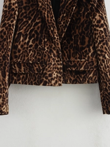 Close-up detail of leopard print blazer with soft velvet texture and classic flap pocket
