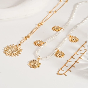 Three-piece gold metal jewelry set with sun pendant necklaces and faux pearl chain