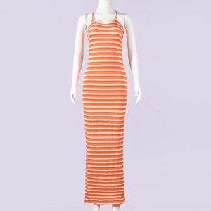 Detail of orange and white striped knit maxi dress texture on a display mannequin