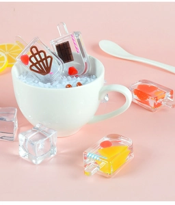 Detailed macro view of miniature resin popsicle charms with fruit slices in a cup