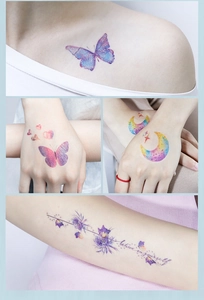 Macro view of butterfly and glitter tattoos with Believe in Yourself text on skin