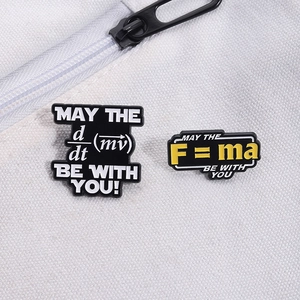 Physics formula enamel pins featuring F=ma and momentum equations on a white canvas bag
