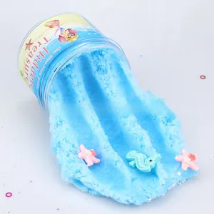 Detail of light blue cloud slime with sea star and seahorse resin charms in a clear jar