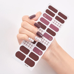 Detail of burgundy and pink plaid self-adhesive nail stickers on model hands