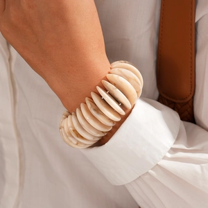 Close-up of bohemian marble pattern acrylic disc stretch bracelet on a female wrist