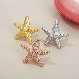 Hollow starfish earrings in gold, silver, and rose gold with textured metal finish
