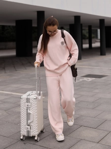 Pink knit two-piece lounge set with long sleeve sweater and wide leg trousers