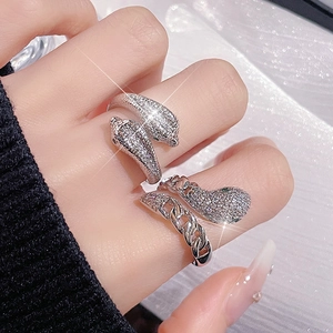 Detail of silver snake rings with cubic zirconia pavé and Cuban chain link design
