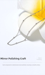 Macro detail of polished S925 sterling silver station necklace with mirror finish