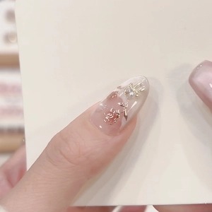 Pink French press-on nails with 3D gold rose embossed patterns and delicate pearls