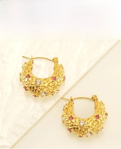 Detail of 18K gold plated C-hoop earrings with diamond pattern and pink zircons