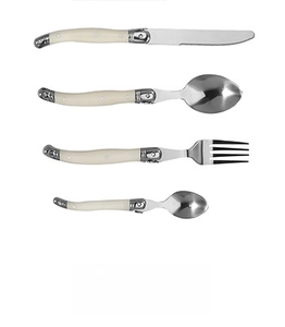 Detail of Laguiole style cutlery set with cream handles and signature bee motif