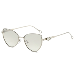 Cat-eye metal sunglasses with heart crystal detail and pale gold frame in 45-degree view