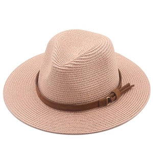 Pink orange straw panama hat with a dark brown leather band and metallic buckle