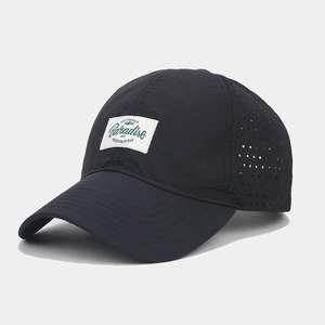 Detail view of laser-cut side vents on quick-dry black baseball cap with Paradise patch
