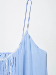 Macro detail of a light blue camisole with delicate white lace trim and ribbed texture