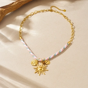 Golden sunflower pendant necklace with colorful braided cord in a bohemian style
