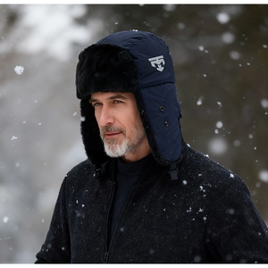 Detail of navy blue winter trapper hat with faux fur lining and adjustable ear flaps