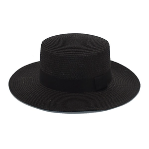 Detailed view of black straw boater hat featuring a matching grosgrain ribbon band