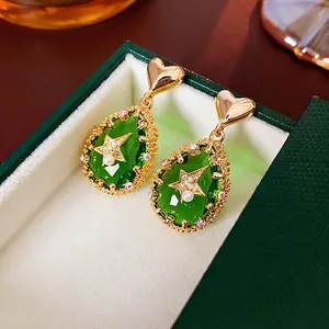 Golden heart earrings with green teardrop zircon, star inlay and pearl detail