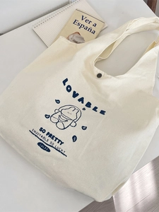 Cute off-white canvas tote bag with blue cartoon bear print and snap button closure