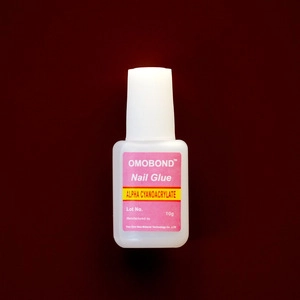 Macro shot of 10g OMOBOND professional nail glue bottle with medical alpha cyanoacrylate