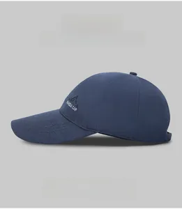 Detail of embroidered mountain peaks and PAHODA CAP text on a cotton baseball cap