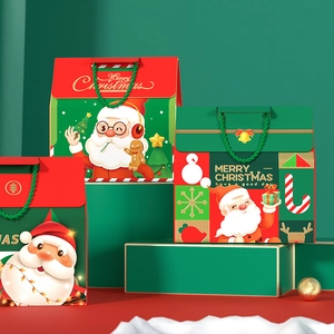 Christmas gift bags with Santa illustrations and woven handles on a tiered green display