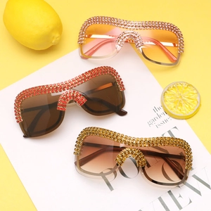 Macro detail of oversized punk sunglasses with gradient lenses and rhinestone-encrusted metal frames