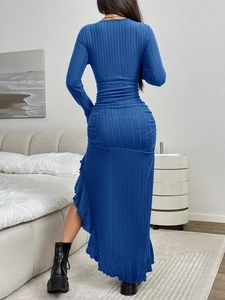 Detail of blue ribbed knit dress featuring a fitted waist and ruffled irregular hemline