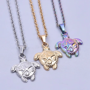 Detailed relief of sea turtle pendants in silver, gold, and rainbow stainless steel