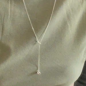 Elegant 925 sterling silver Y-shaped necklace with heart pendant on olive fabric