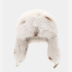 Plush faux fur trapper hat in cream and brown spots for winter warmth and outdoor skiing