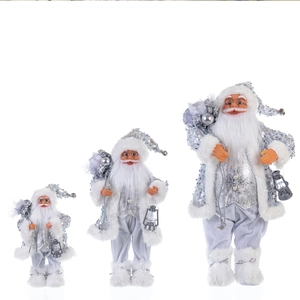 Three silver sequined Santa Claus figurines with lanterns in various sizes on white background