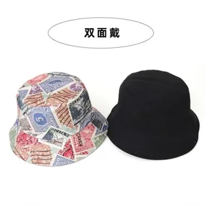 Reversible bucket hat with vintage colorful stamp print and plain black side